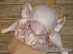 Carefully separate the skin from the flesh on the breast side using a knife. Also carefully separate the skin from the back. Remove the skin from the legs, break them and cut them at the joint. Place the legs back into the skin. Also trim the wings at the joints. 