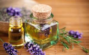 Sage oil and flowers on a wooden table