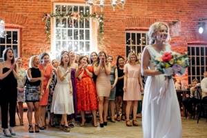 The bride throws a bouquet to the stand-in