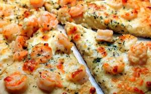 Shrimp pizza. Recipes at home in the oven, in a frying pan with arugula, mushrooms, pineapples, squid 