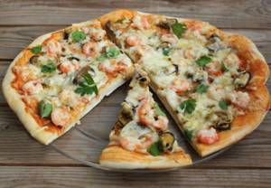 Shrimp pizza. Recipes at home in the oven, in a frying pan with arugula, mushrooms, pineapples, squid 