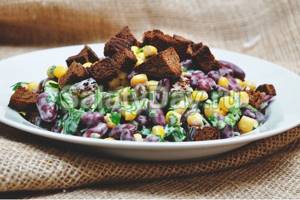 Salad of beans, corn with croutons and curd sauce