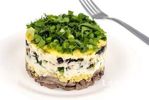Layered salad with tongue, fresh cucumber and prunes