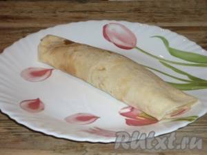 Roll the pancake into a tube so that the filling is inside.