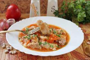 Pork with beans in tomato sauce