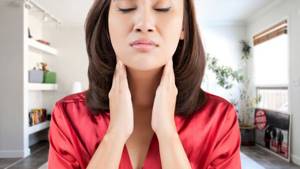 Asian woman has a sore throat
