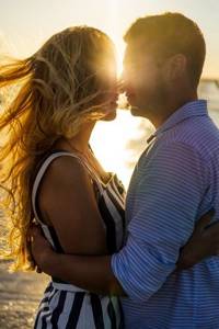 Couple in love indulges in pleasure at sunset